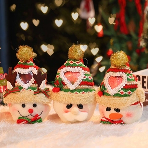 Three Christmas burlap gift bags featuring Santa, Reindeer, and Snowman on a cozy white rug