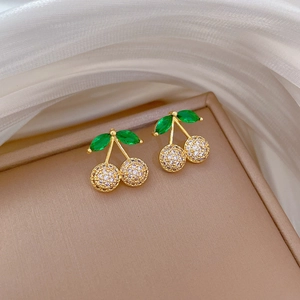 Detail of cherry stud earrings with green leaf stones and white zircon pavé settings