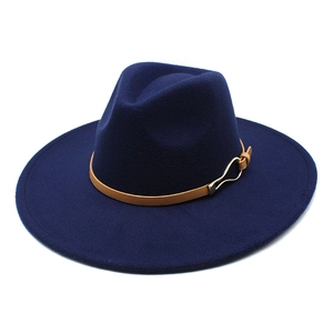 Detail of navy blue wool fedora with brown leather strap and golden buckle