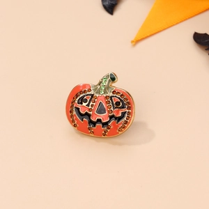 Close-up of Halloween pumpkin brooch featuring orange rhinestones and green leaf detail