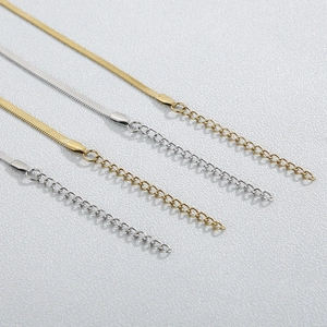 Close-up of gold and silver stainless steel flat herringbone and link chains