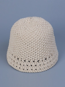 Detailed close-up of cream handmade crochet bucket hat featuring intricate hollow patterns