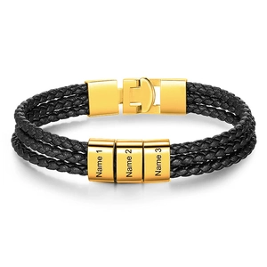 Macro shot of triple-layer black leather bracelet with three customizable gold steel rings
