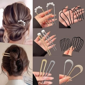 Detailed views of elegant pearl-embellished metal hair pins and U-shaped clips for styling