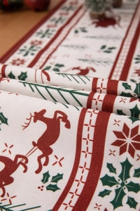 Close-up of woven fabric Christmas table runner with red reindeer and holly leaf patterns