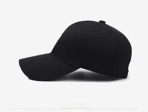 Close-up of black cotton baseball cap showing detailed white side embroidery and curved brim