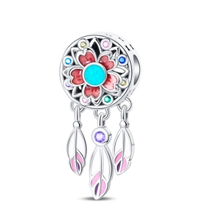 Detailed macro of a dreamcatcher charm with colorful enamel floral inlay and silver feathers