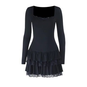 Detail of black square neck dress featuring intricate lace layered ruffles on the hemline