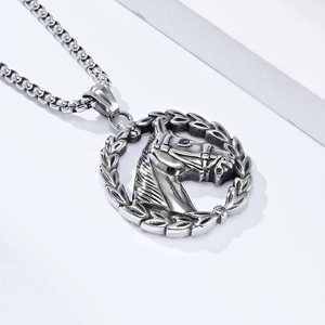 Detail of silver horse head relief pendant with laurel wreath on a steel box chain