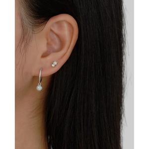 Close-up of S925 silver hoop earrings with white opal stones and sparkling zircon pavé