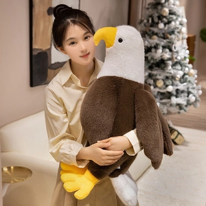 Realistic large bald eagle plush toy displayed in a cozy home setting near a Christmas tree