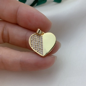 Gold-plated heart pendant with sparkling cubic zirconia on a minimalist soft white background