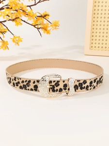 Detailed view of leopard print belt with golden rhinestone horseshoe buckle and hair-on leather