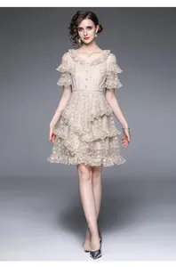 Detail of elegant apricot lace dress with luxury embroidery and ruffled hemline