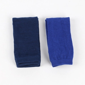 Detailed view of dark blue and royal blue knitted cotton arm warmers with ribbed texture