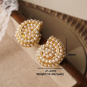 Macro detail of gold vintage shell earrings with white pearls, size 24mm by 21.2mm