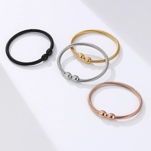 Detail view of twisted magnetic therapy bracelets in black, gold, silver and rose gold