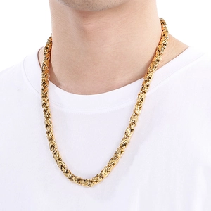 Macro shot of 18k gold Byzantine braided titanium steel chain necklace on a model
