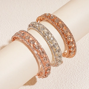 Three-layer zircon pavé open bangles in rose gold and silver finishes on display