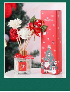 Macro shot of Christmas reed diffuser with red berries, white flowers and holiday packaging