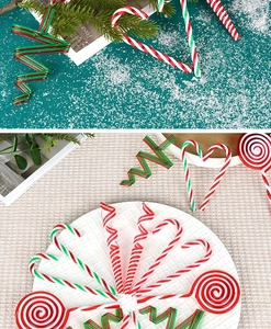 Macro detail of red and green candy cane ornaments on a snowy festive background
