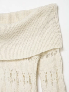 Close-up of off-white hollow knit texture and ribbed collar on long sleeve sweater