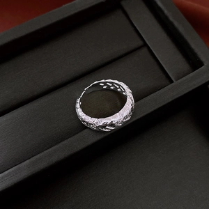 Macro detail of silver woven twist open ring with sparkling cubic zirconia inlay