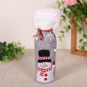Detail of grey felt Christmas wine bottle cover with snowman embroidery and faux fur trim