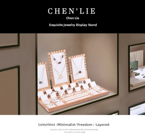 Detailed set of wooden jewelry display stands with white necklace boards and ring slots