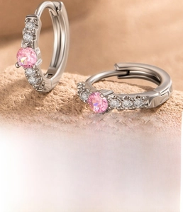 Macro shot of silver zircon hoop earrings showing a 10mm inner diameter and pink stones