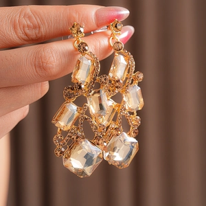 Detailed shot of vintage gold earrings with champagne crystals and sparkling rhinestones