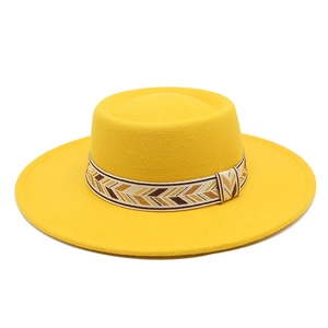 Close-up of a yellow wool felt boater hat with a bohemian geometric patterned hatband