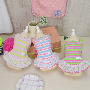 Three colorful striped pet dresses with lace hems displayed on miniature mannequins