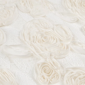 Macro shot of 3D rose embroidery on premium cream lace fabric for women's dress