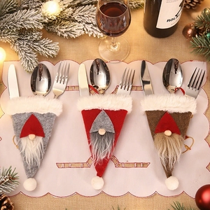 Close-up of Nordic gnome cutlery holders in grey, red, and brown felt for Christmas decor