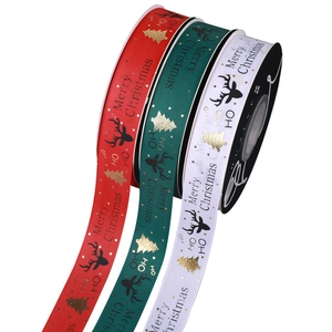 Three rolls of Christmas grosgrain ribbons with gold foil reindeer and Merry Christmas prints
