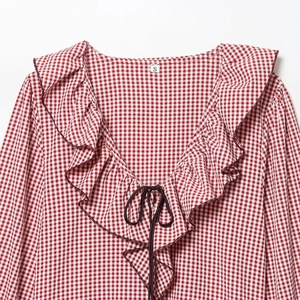 Women's red and white plaid shirt with ruffle V-neck and decorative tie detail