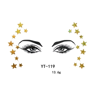 Close-up detail of gold glitter star face stickers, perfect for festival and party makeup.