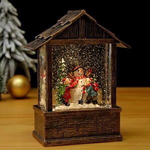 Vintage bronze Christmas lantern with kids, snowman miniature and swirling glitter snow
