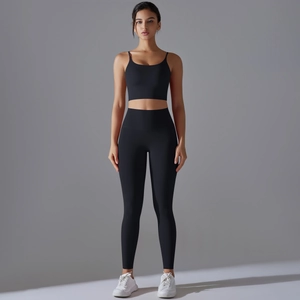 Detail of black high-waisted yoga set featuring slim strap sports bra and leggings