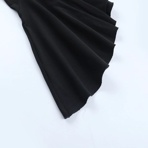 Detail view of the elegant bell sleeve and high-quality black knit fabric of the dress