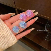 Detail of floral stud earrings in pink and blue purple with resin flower petals