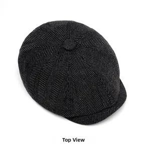 Top view of classic charcoal herringbone newsboy cap showing tweed texture and wool blend