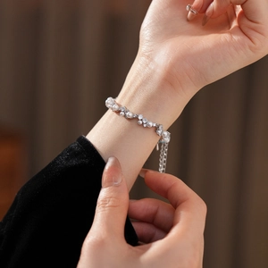 Close-up of pearl and zircon bracelet with silver base on a model's wrist