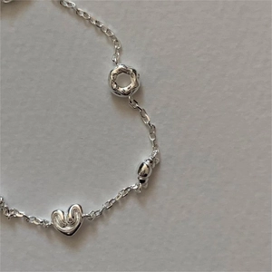 Minimalist S925 sterling silver bracelet with heart, donut and croissant shaped charms