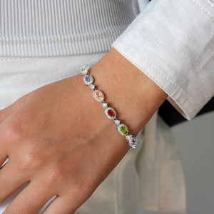 Detail of flower-shaped oval crystal and pearl bracelet worn on a female wrist