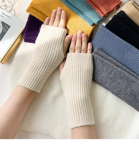 Close-up of knitted fingerless gloves with vertical ribbed texture in various colors