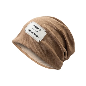 Brown knit slouchy beanie for women with soft beige lining and seasonal patch design