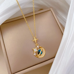 Luxury gold titanium necklace featuring moon and star pendants with blue planet stone