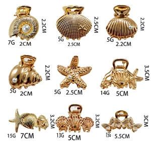 Miniature gold metal hair claws with shell and starfish designs and faux pearls